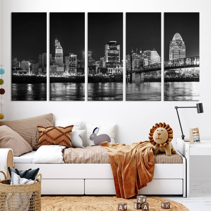 The Cincinnati City Lights Skyline Black and White Wall Art Cityscape Canvas Print elegantly adorns a modern living room. This museum-quality canvas triptych of a city skyline is enhanced by hand-assembled frames for added finesse, and you can enjoy free shipping on this stunning home addition.