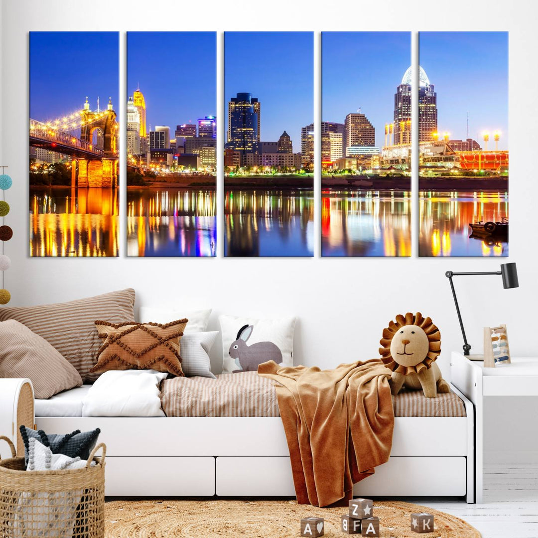 The "Cincinnati City Lights Night Skyline Cityscape View Wall Art Canvas Print" is a gallery-wrapped, museum-quality canvas illustrating a lit-up bridge and skyline at night. Enhanced with a UV-protective coating, this piece ensures lasting vibrancy.