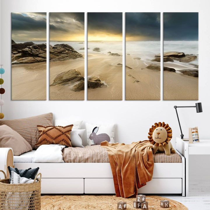 A gallery-wrapped, three-panel artwork titled "Rocks and Waves Wall Art Canvas Print" depicts a rocky beach at sunset. Each canvas showcases museum-quality craftsmanship and a UV-protective coating to maintain its vibrant colors.