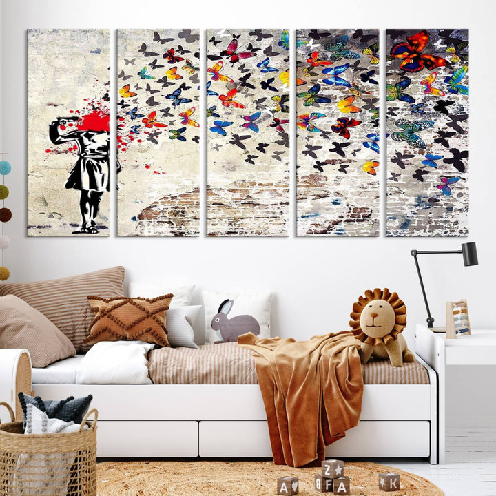 The Banksy Art Butterfly Girl Explosion Canvas showcases a dynamic figure with butterflies bursting from their head, set against a textured wall background. This vibrant urban graffiti piece is perfect for modern interiors and comes ready to hang.