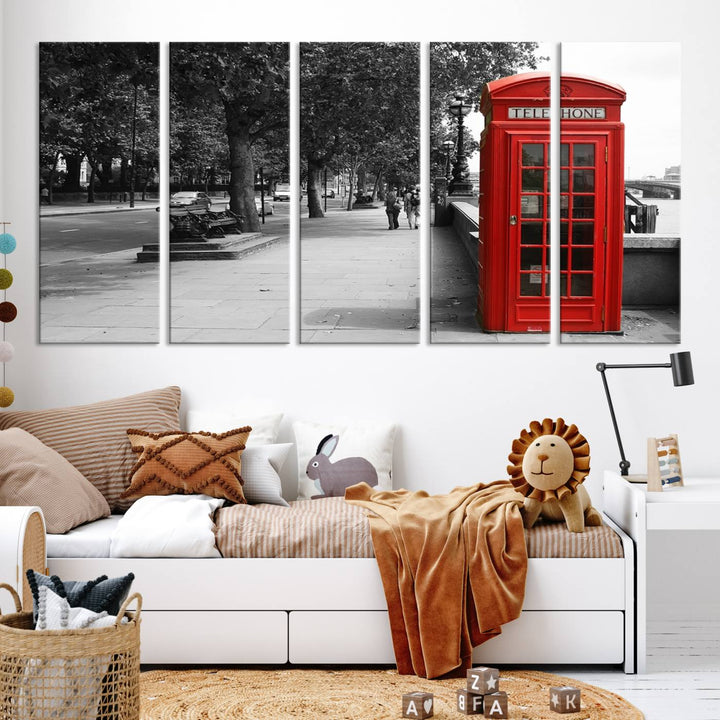 The London Phone Club Wall Art is a stunning piece that showcases a red telephone box set in a black and white street scene on museum-quality canvas. It is gallery wrapped with a UV-protective coating to preserve its vibrant charm.