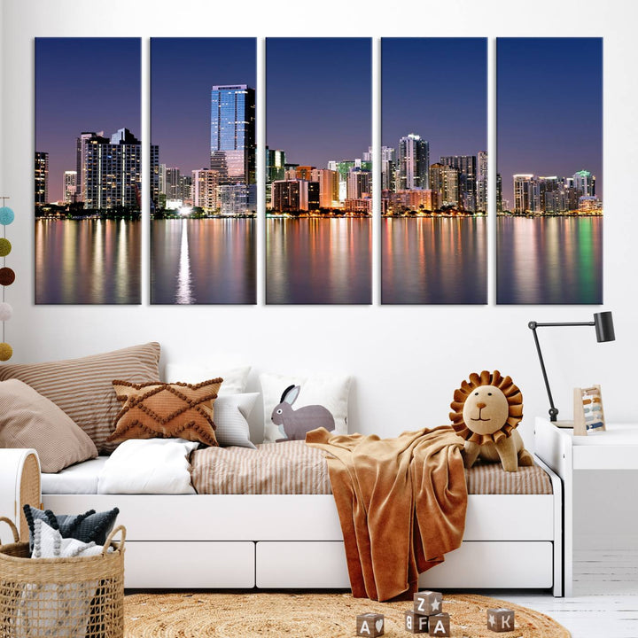 The Miami Skyline Canvas Wall Art Print showcases a vibrant night cityscape and beautifully captures the dazzling colorful lights reflecting on the water. This ready-to-hang triptych adorns the wall, creating a stunning visual centerpiece.