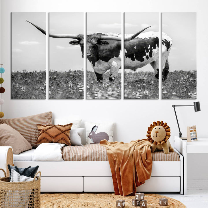 The Texas Black White Highland Longhorn Cow Wall Art Canvas Print, a gallery-quality triptych, elegantly adorns the wall, showcasing a striking black-and-white depiction of a longhorn cow in a field.