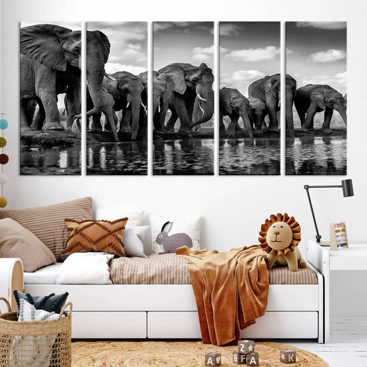 A stunning "Wall Art Animal Canvas Print" featuring a black and white photo of a herd of elephants drinking water is elegantly displayed, gallery wrapped on museum-quality canvas.