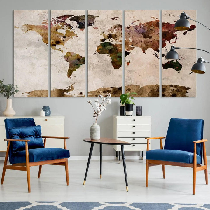 A Watercolor World Map Canvas Print, wrapped in an elegant gallery style, hangs on the wall.