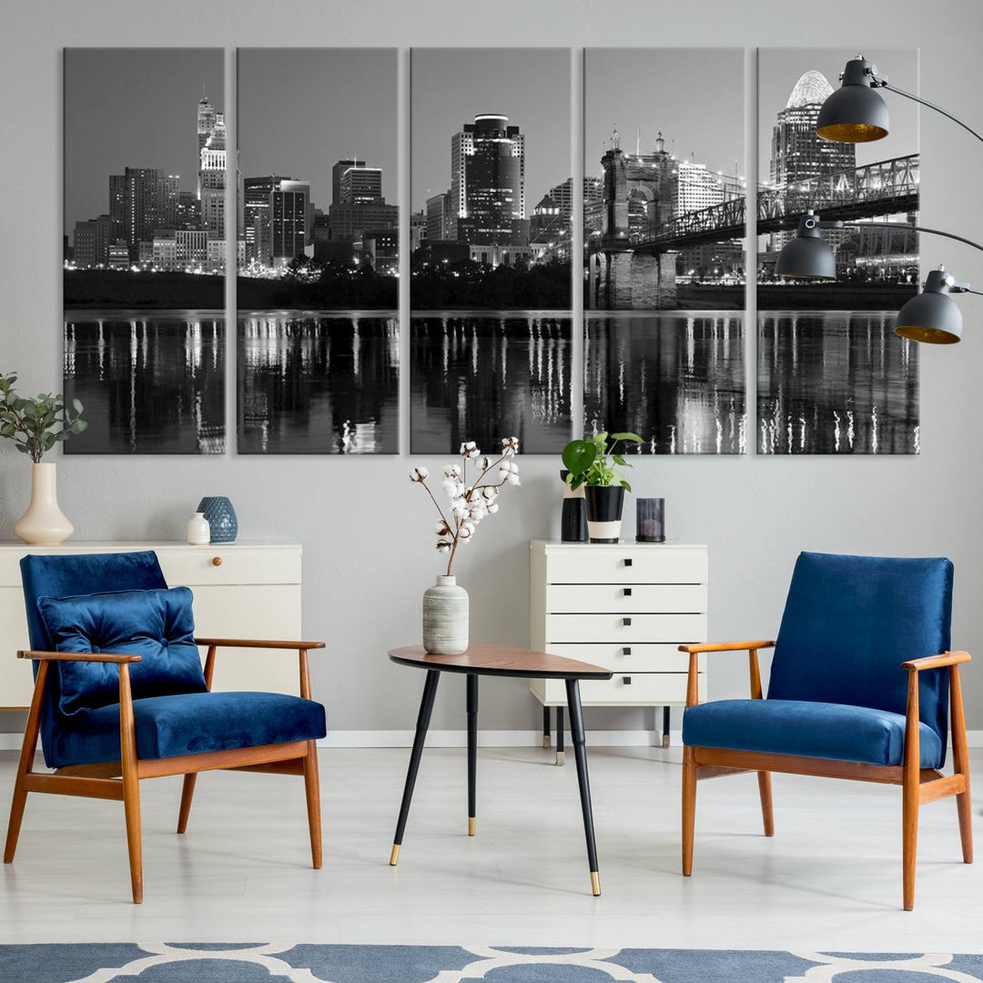 The wall showcases a ready-to-hang triptych of the Cincinnati City Lights Skyline in black and white, printed on museum-quality canvas.