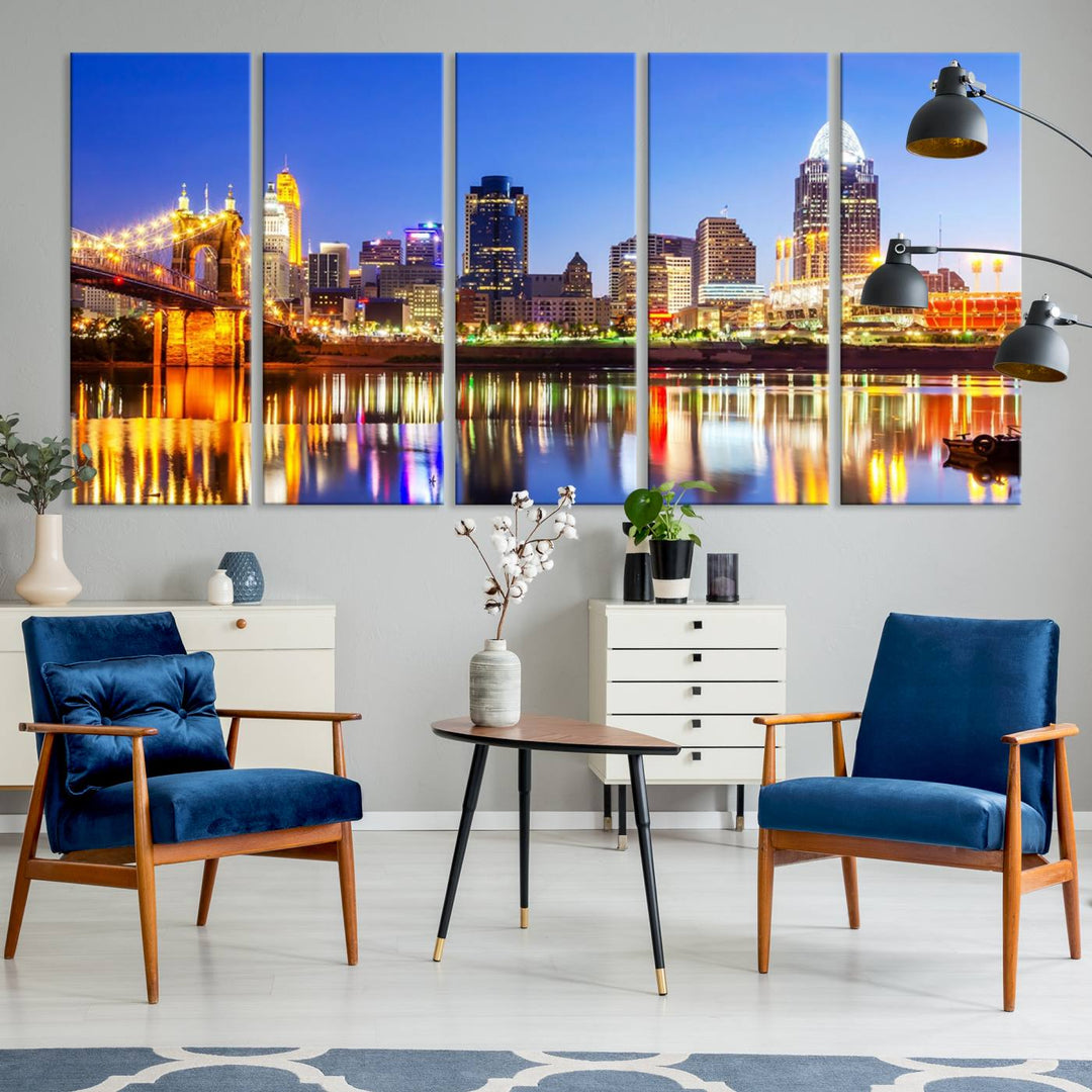 The "Cincinnati City Lights Night Skyline Cityscape View Wall Art Canvas Print" is a gallery-wrapped, museum-quality canvas illustrating a lit-up bridge and skyline at night. Enhanced with a UV-protective coating, this piece ensures lasting vibrancy.