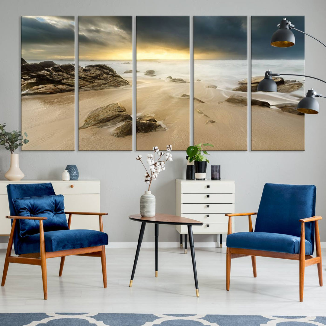 A gallery-wrapped, three-panel artwork titled "Rocks and Waves Wall Art Canvas Print" depicts a rocky beach at sunset. Each canvas showcases museum-quality craftsmanship and a UV-protective coating to maintain its vibrant colors.