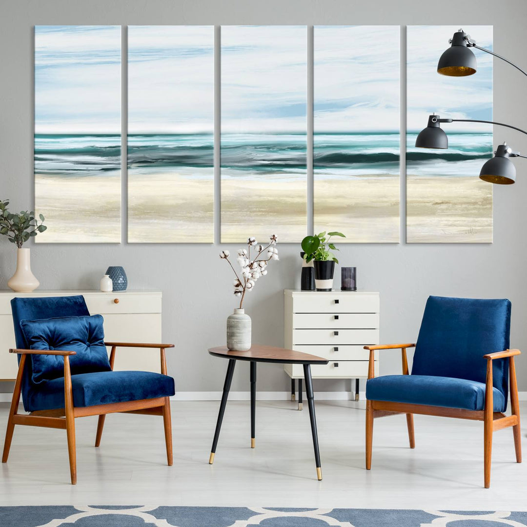 The room features the Ocean Abstract Wall Art Canvas Print, a triptych beach painting on museum-quality canvas with a gallery-wrapped finish and UV-protective coating.