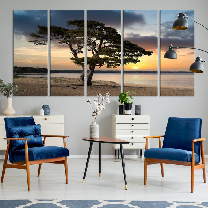 The room showcases the Coastal Sunset Wall Art Canvas Print, a triptych elegantly displayed on museum-quality polycotton canvas, depicting a serene beach sunset with a tree.