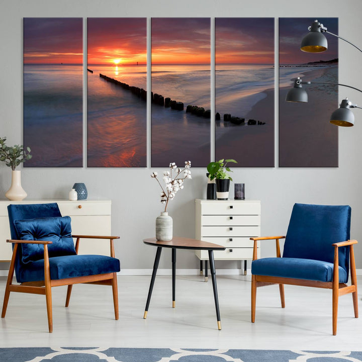 In a modern living room, the Sunset Beach Wall Art Canvas Print is displayed above. This triptych, printed on museum-quality canvas with a UV-protective coating, ensures lasting brilliance. It's ready to hang and brings an elegant touch to your space.