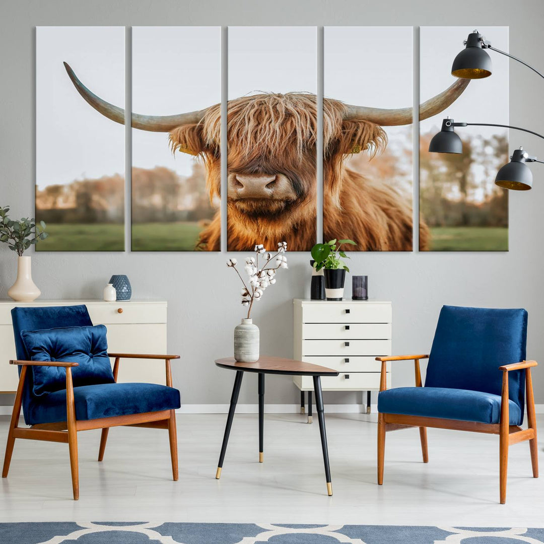 A Highland Cow Animal Scottish Cattle Art Print Farmhouse Wall Art Canvas Print hangs in the living room, adding a touch of rustic farmhouse decor.