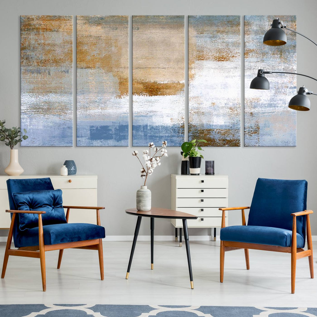 The Blue Multi Panel Abstract Wall Art Canvas Print, featuring an elegant blend of blue, beige, and brown tones, hangs gracefully on the wall, adding a contemporary touch to the space.