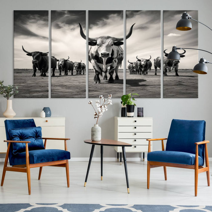 The Black and White Longhorn Cattle Wall Art, featuring a three-panel display of cowboy Western longhorns walking toward the viewer, enhances your space with its striking presence, adding a touch of Western decor.