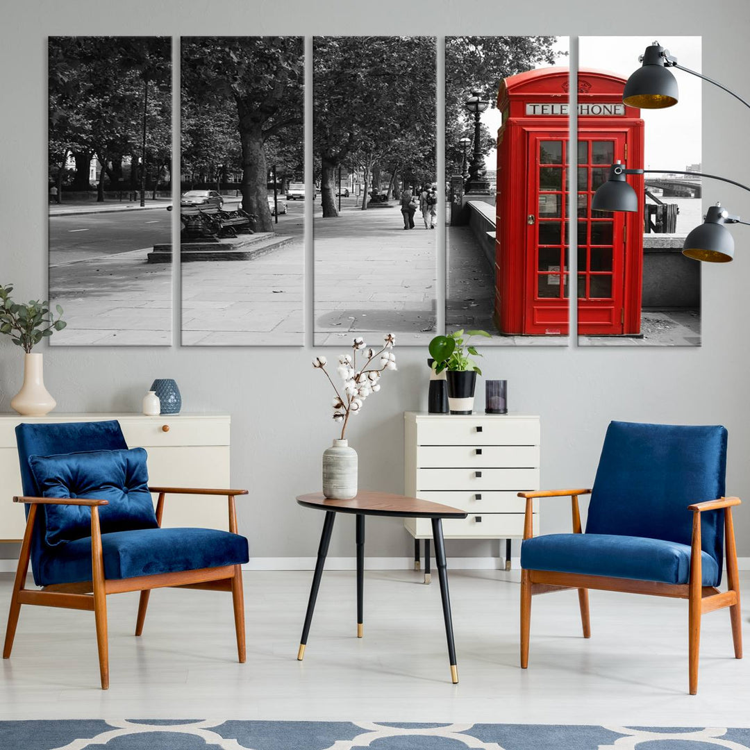 The London Phone Club Wall Art is a stunning piece that showcases a red telephone box set in a black and white street scene on museum-quality canvas. It is gallery wrapped with a UV-protective coating to preserve its vibrant charm.