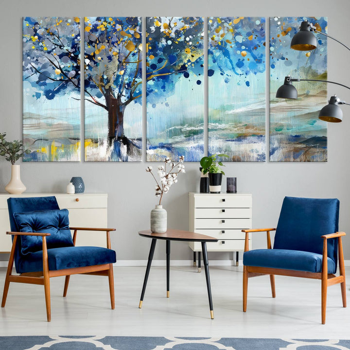 A modern living room features a three-panel Watercolor Style Abstract Tree Printing Wall Art Canvas in vibrant blue and yellow, crafted on museum-quality material.