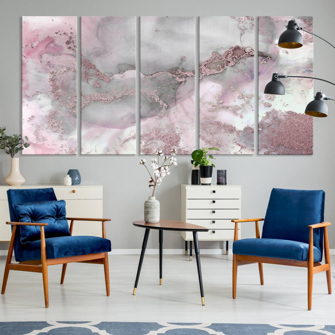 The Rose Marble Abstract Wall Art Canvas Print is a stunning triptych that showcases pink and gray tones, elegantly presented on a dark wall.