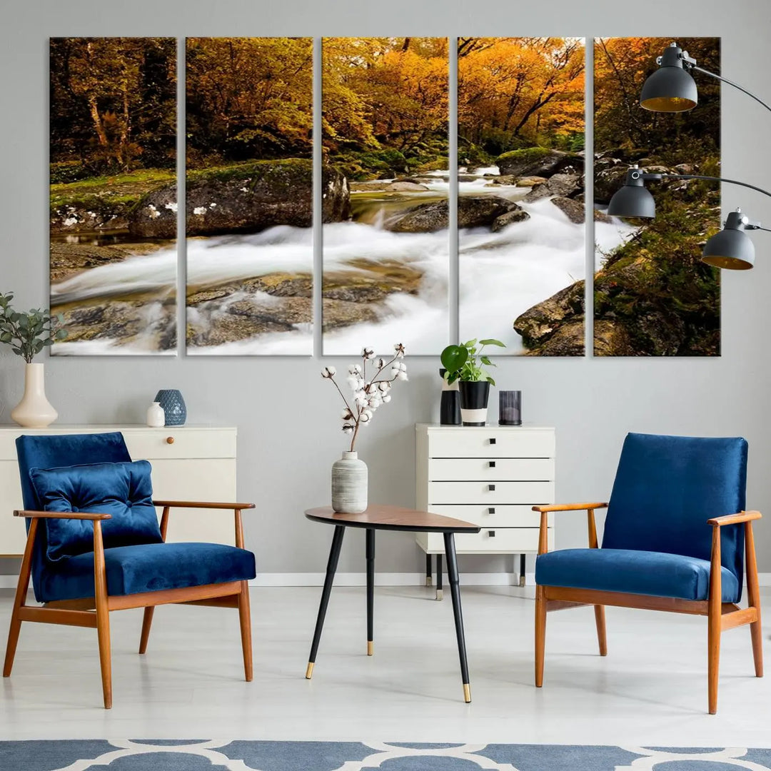 The living room is adorned with the "Wall Art Waterfall Canvas Print River in Forest in Autumn," a triptych on museum-quality canvas showcasing a flowing river surrounded by autumn trees. This ready-to-hang artwork features a UV-protective coating to ensure enduring vibrancy.