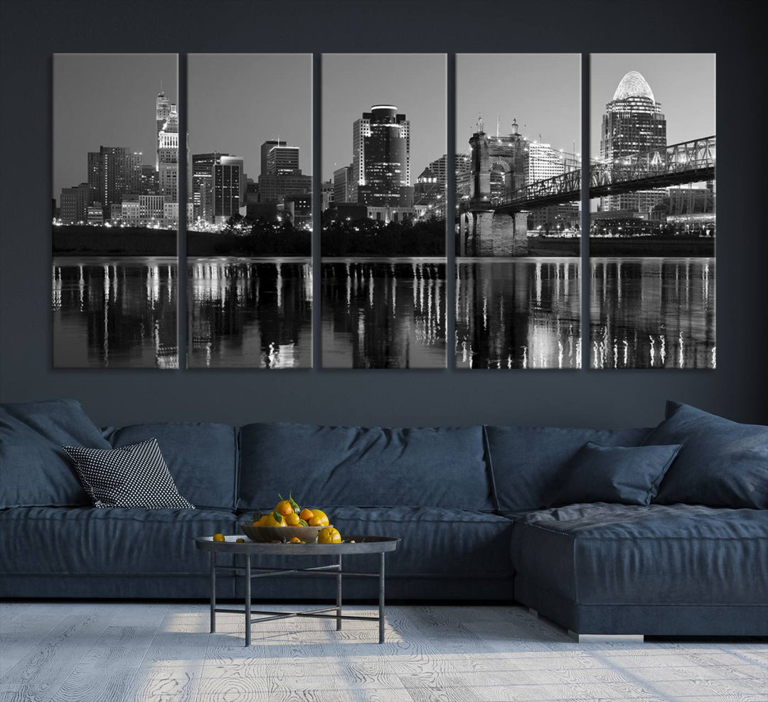 The wall showcases a ready-to-hang triptych of the Cincinnati City Lights Skyline in black and white, printed on museum-quality canvas.