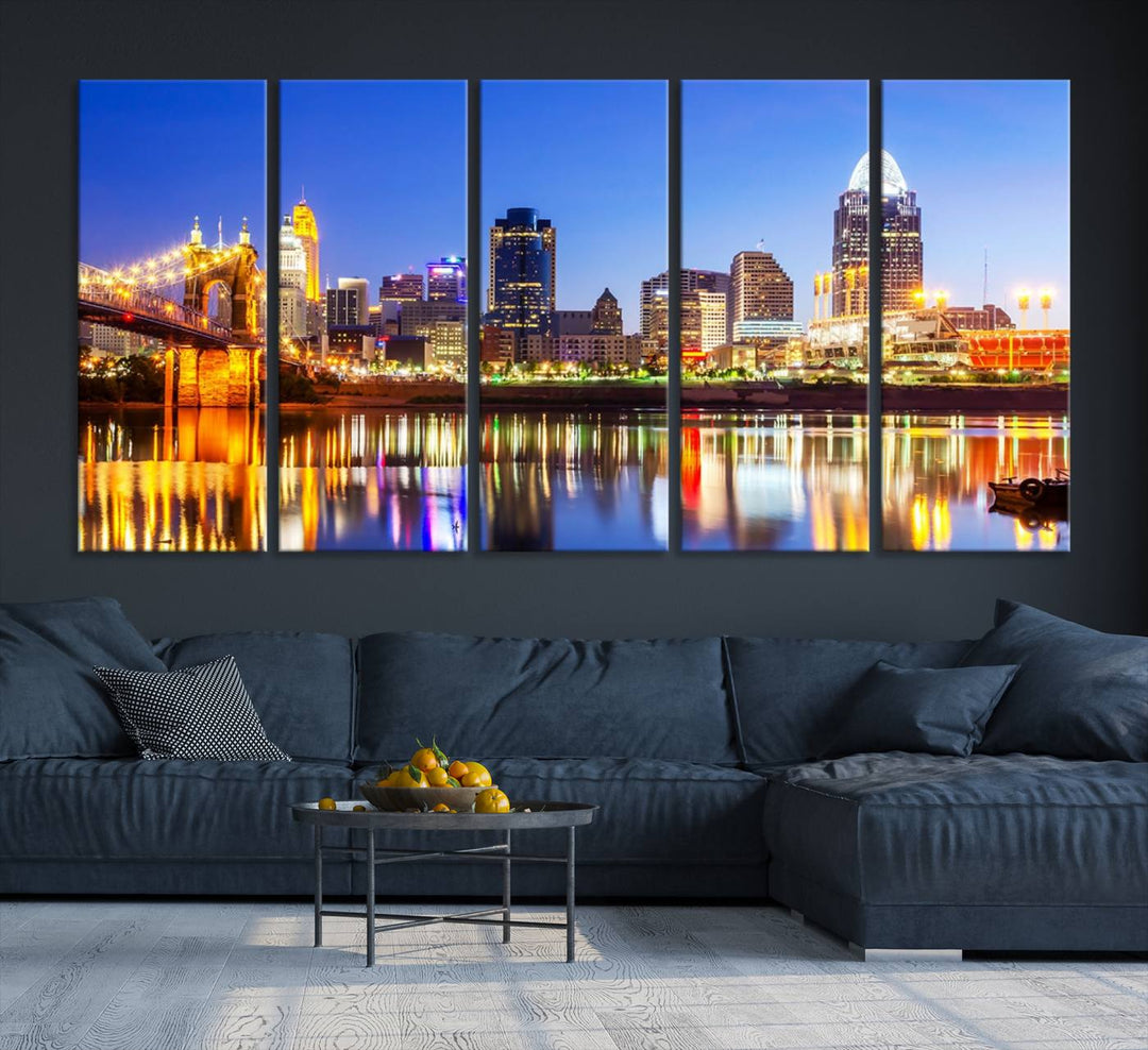 The "Cincinnati City Lights Night Skyline Cityscape View Wall Art Canvas Print" is a gallery-wrapped, museum-quality canvas illustrating a lit-up bridge and skyline at night. Enhanced with a UV-protective coating, this piece ensures lasting vibrancy.