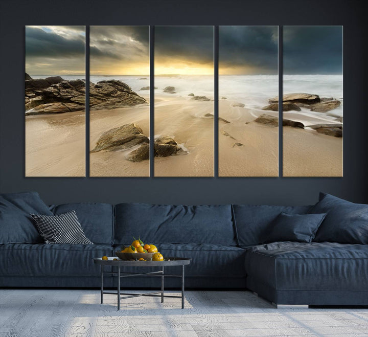 A gallery-wrapped, three-panel artwork titled "Rocks and Waves Wall Art Canvas Print" depicts a rocky beach at sunset. Each canvas showcases museum-quality craftsmanship and a UV-protective coating to maintain its vibrant colors.