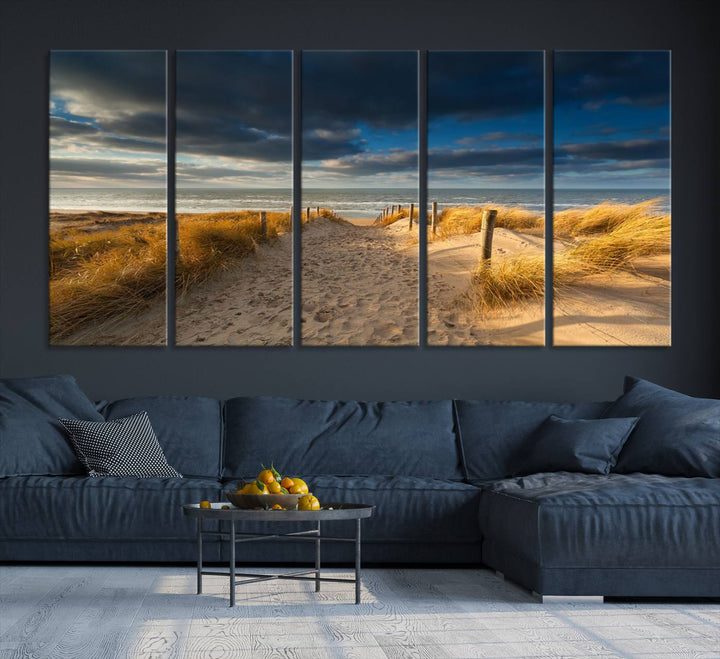 The Ocean Beach Dark Clouds Wall Art Canvas Print is a breathtaking triptych depicting a sandy beach path with tall grasses under an intense cloudy sky. It is crafted on museum-quality canvas with UV protection.