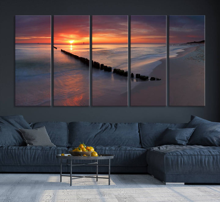 In a modern living room, the Sunset Beach Wall Art Canvas Print is displayed above. This triptych, printed on museum-quality canvas with a UV-protective coating, ensures lasting brilliance. It's ready to hang and brings an elegant touch to your space.