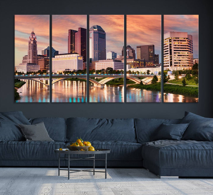 The "Columbus City Lights Sunset Orange Cloudy Skyline Cityscape View" wall art is featured on the wall. This triptych is printed on museum-quality canvas and includes a UV-protective coating, ensuring lasting vibrancy.