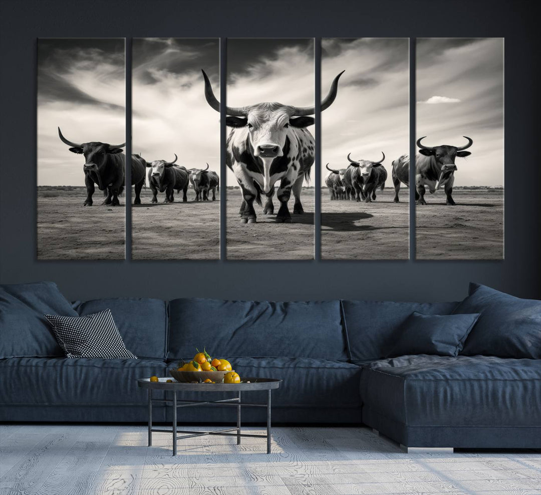 The Black and White Longhorn Cattle Wall Art, featuring a three-panel display of cowboy Western longhorns walking toward the viewer, enhances your space with its striking presence, adding a touch of Western decor.