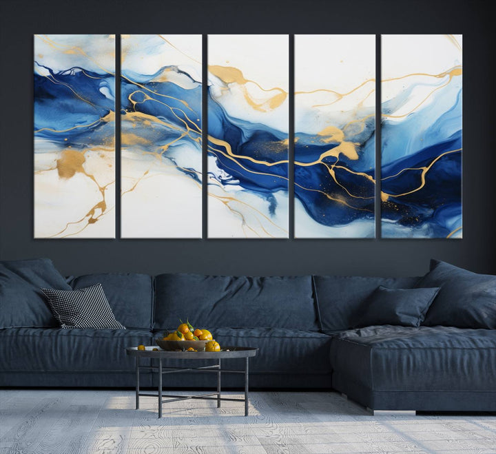 The Blue Abstract Wall Art is displayed as a triptych on museum-quality canvas, showcasing a blue and gold abstract design. The artwork includes a UV-protective coating to maintain its vibrancy and comes with the benefit of free shipping.