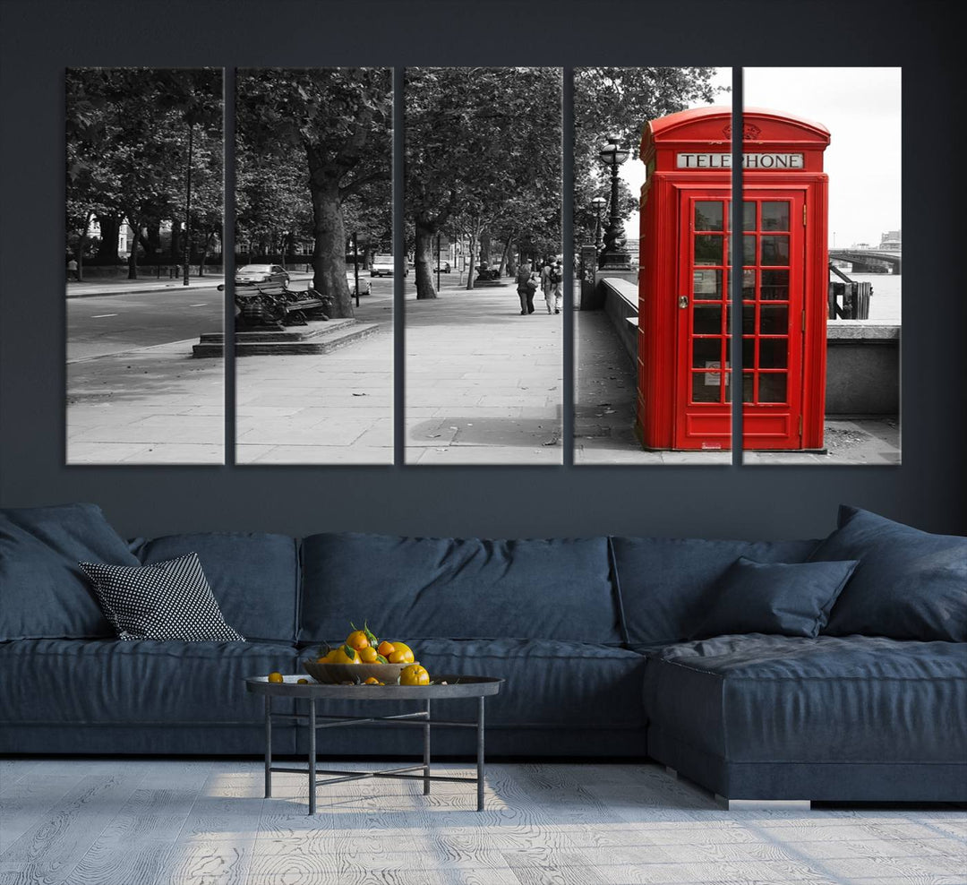 The London Phone Club Wall Art is a stunning piece that showcases a red telephone box set in a black and white street scene on museum-quality canvas. It is gallery wrapped with a UV-protective coating to preserve its vibrant charm.