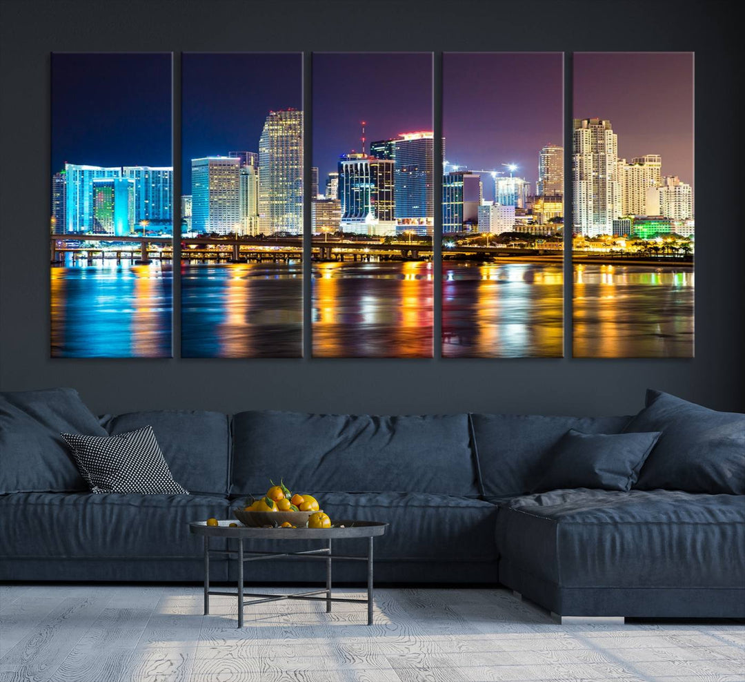 The Wall Art MIAMI Canvas Print features a stunning triptych of a city skyline at night, with vibrant lights reflecting on the water. This gallery-wrapped piece on museum-quality canvas delivers an exquisite finish.