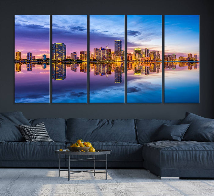 The Miami City Wall Art Canvas Print, featuring a three-panel depiction of a city skyline at sunset reflected in water, beautifully enhances the wall. Made with museum-quality canvas and a UV-protective coating, it comes ready to hang.