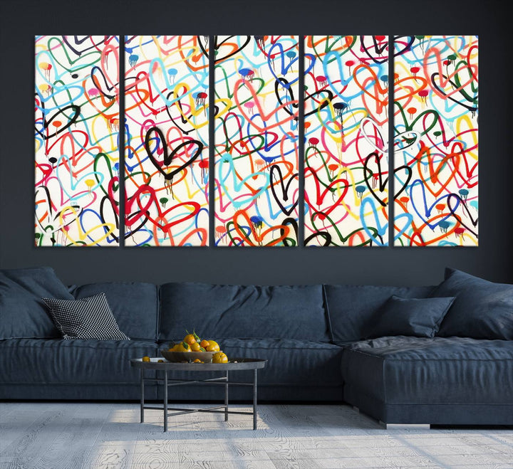 The Colorful Graffiti Love Canvas Print, a street art masterpiece with vibrant abstract swirls and a gallery-quality finish, hangs prominently on the wall.