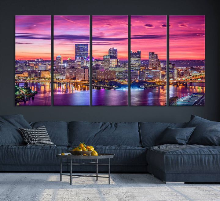 The Pittsburg Wall Art Canvas Print, showcasing a vibrant sunset glow over the city skyline and crafted by a professional artisan, adorns the space.