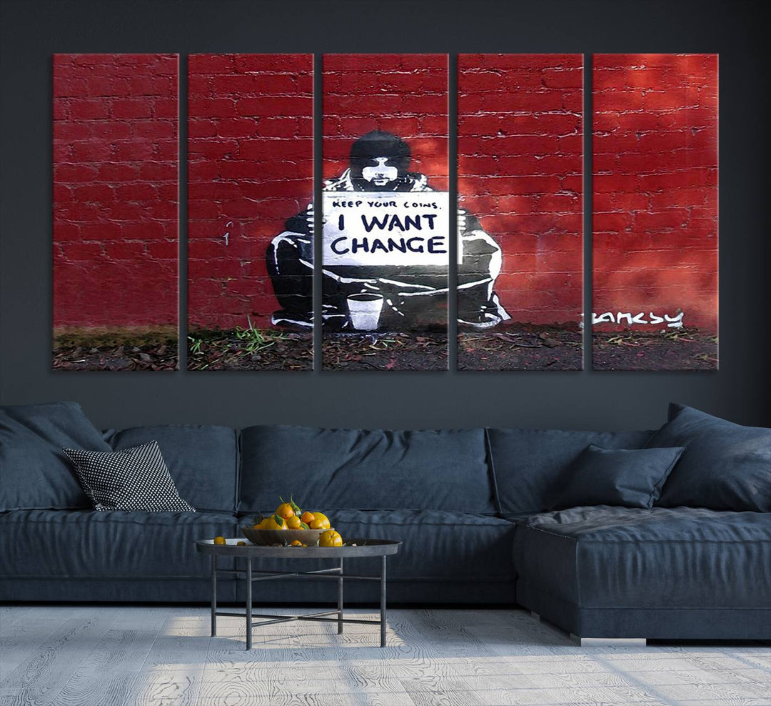 The living room showcases a triptych of stencil artwork on museum-quality canvas, featuring the Banksy I Want Change Graffiti Abstract Wall Art Canvas Print. This captivating piece depicts a person holding a sign that says "I want change" and is finished with a UV-protective coating to ensure long-lasting beauty.