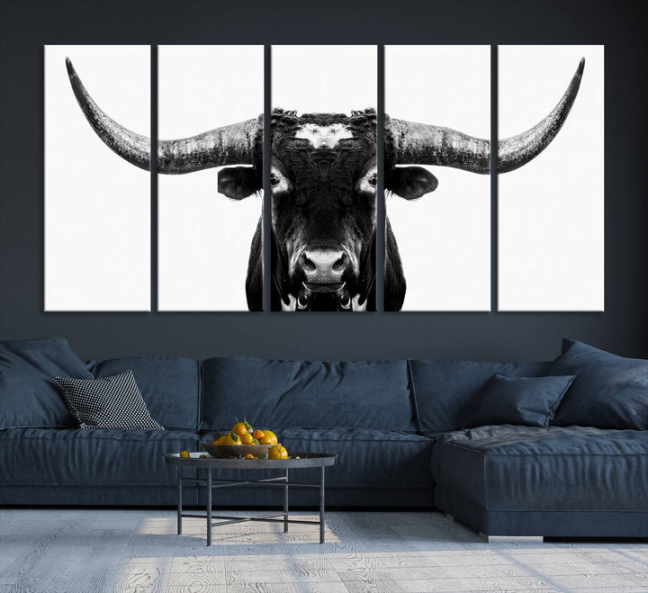 The living room is adorned with the Texas Cow Longhorn Wall Art Canvas Print in Black and White—framed and ready to hang.