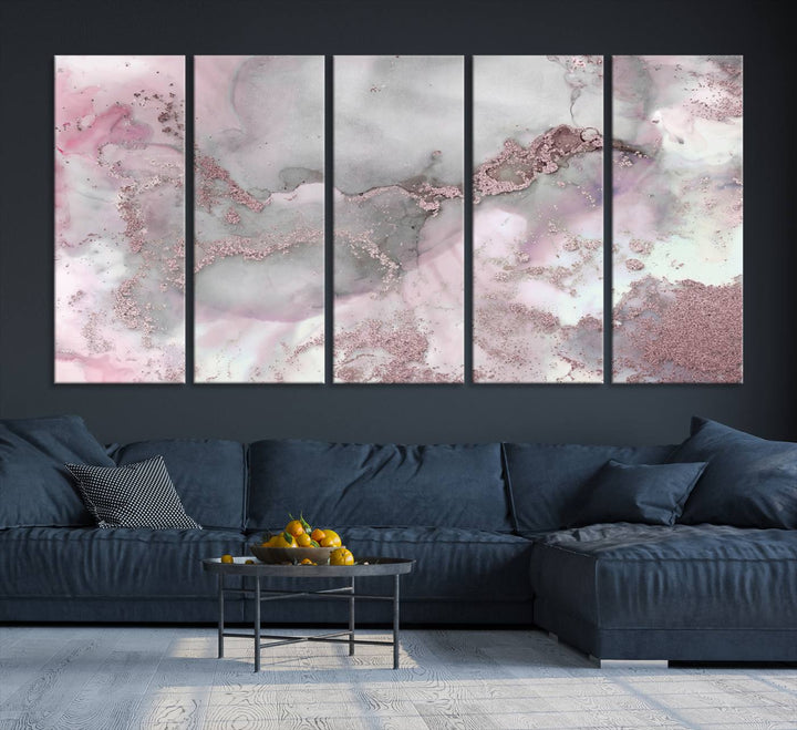 The Rose Marble Abstract Wall Art Canvas Print is a stunning triptych that showcases pink and gray tones, elegantly presented on a dark wall.