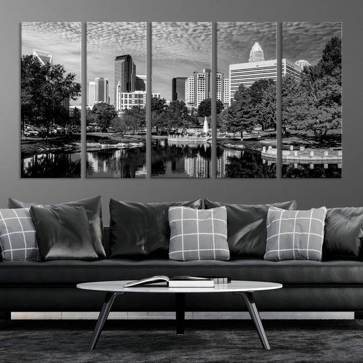 The living room features a captivating triptych titled "Charlotte City Cloudy Skyline Black and White Wall Art Cityscape Canvas Print," crafted on museum-quality canvas with UV-protective coating. Modern decor accentuates the dynamic scene.