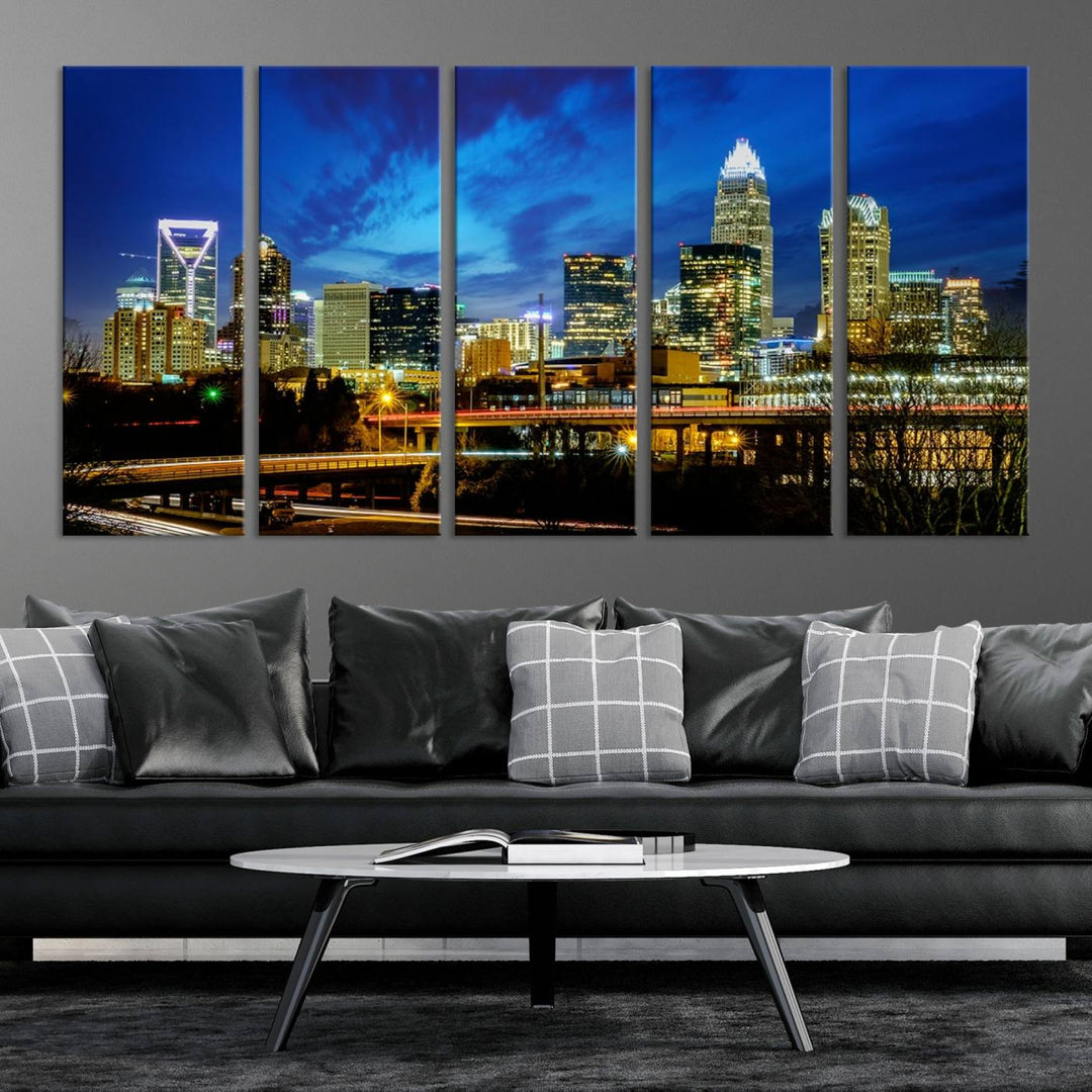 A modern living room highlighted by the "Charlotte City Lights Cloudy Blue Night Skyline Cityscape View" wall art canvas print, crafted on museum-quality canvas with UV-protective coating.