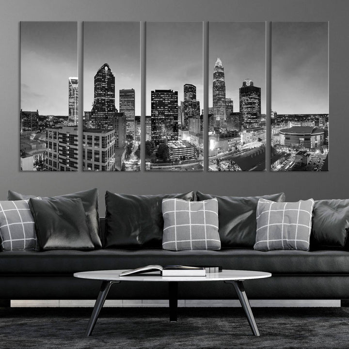 The "Charlotte City Cloudy Skyline Black and White Wall Art Cityscape Canvas Print" hangs on a dark wall, showcasing its UV-protective properties for enduring beauty.