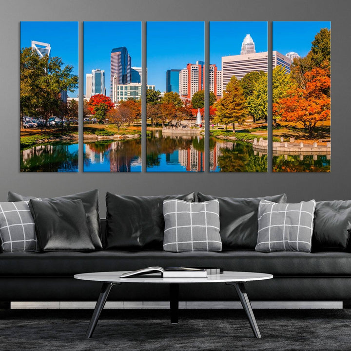 The Charlotte City Park at Fall Skyline Cityscape View wall art canvas print features a city panorama with a park and lake accented by autumn trees. It is mounted on museum-quality canvas with UV-protective coating and decorates the space.