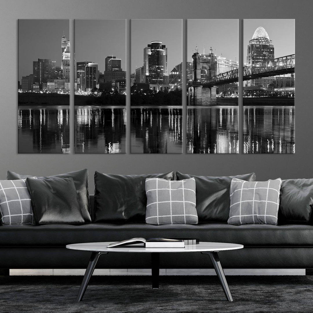 The wall showcases a ready-to-hang triptych of the Cincinnati City Lights Skyline in black and white, printed on museum-quality canvas.