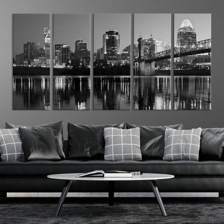 The wall showcases a ready-to-hang triptych of the Cincinnati City Lights Skyline in black and white, printed on museum-quality canvas.