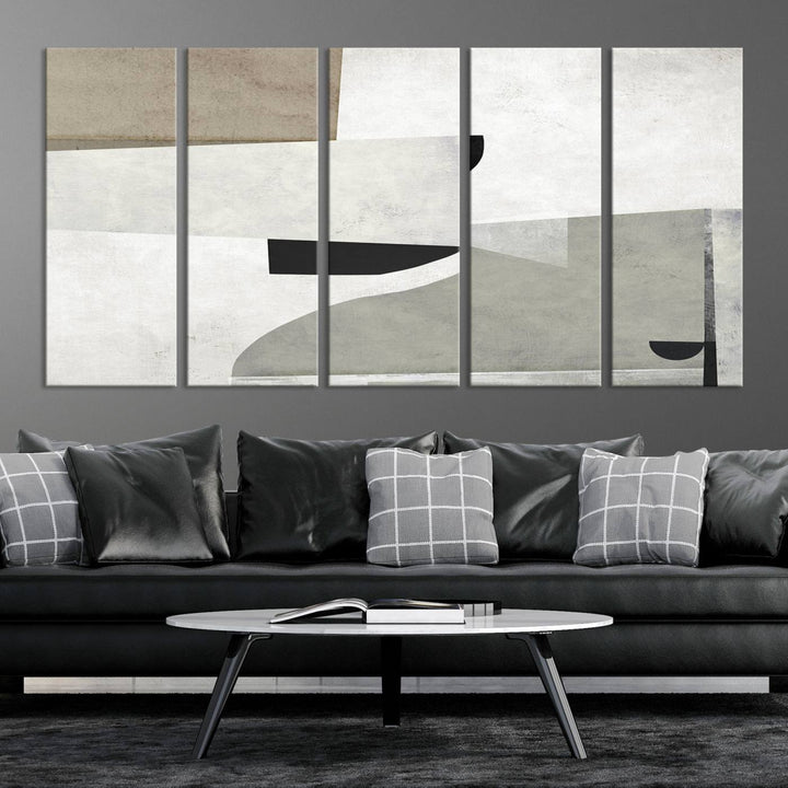 The Brown Gray Figures Abstract Wall Art Canvas Print is displayed as a triptych on a dark wall. The piece is gallery wrapped, offering a seamless finish and enhanced durability due to its UV-protective coating.