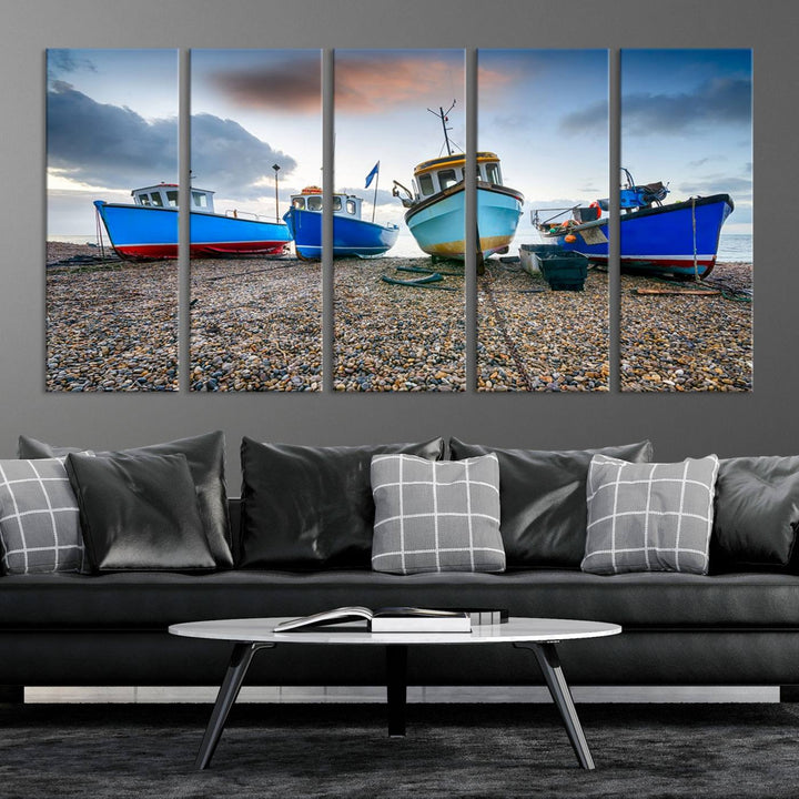 The "Big Boats On The Beach Wall Art Canvas Print" is a stunning piece featuring three museum-quality panels depicting fishing boats on a pebbled shore. Ready to hang and featuring UV-protective coating, it serves as an elegant addition to your home décor.