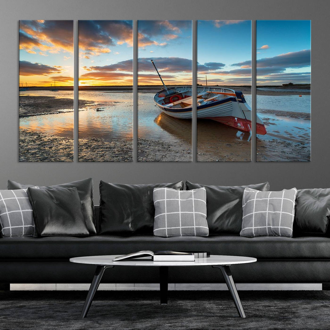 The "Small Boat At The Beach Sunset Wall Art Canvas Print," a three-panel masterpiece crafted on museum-quality canvas, hangs elegantly.