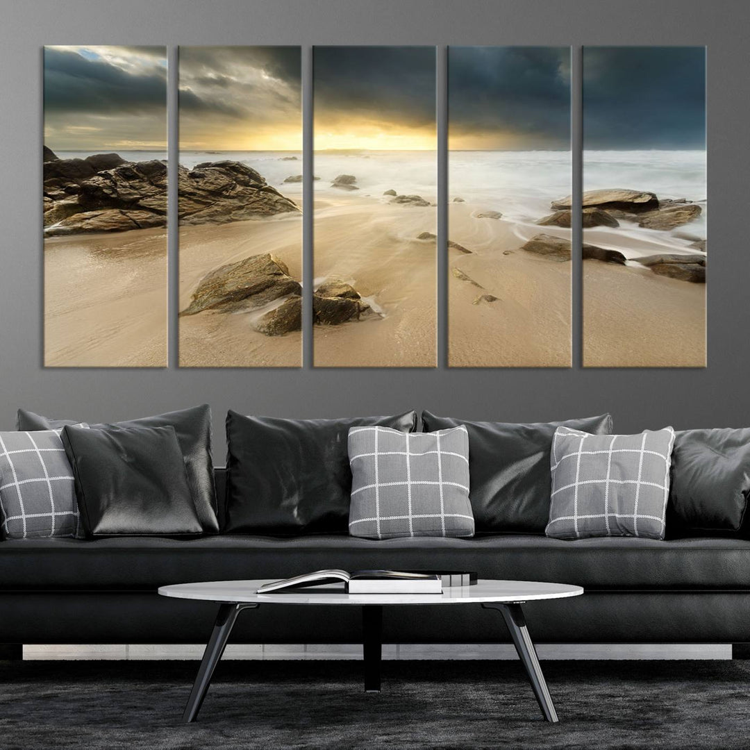 A gallery-wrapped, three-panel artwork titled "Rocks and Waves Wall Art Canvas Print" depicts a rocky beach at sunset. Each canvas showcases museum-quality craftsmanship and a UV-protective coating to maintain its vibrant colors.