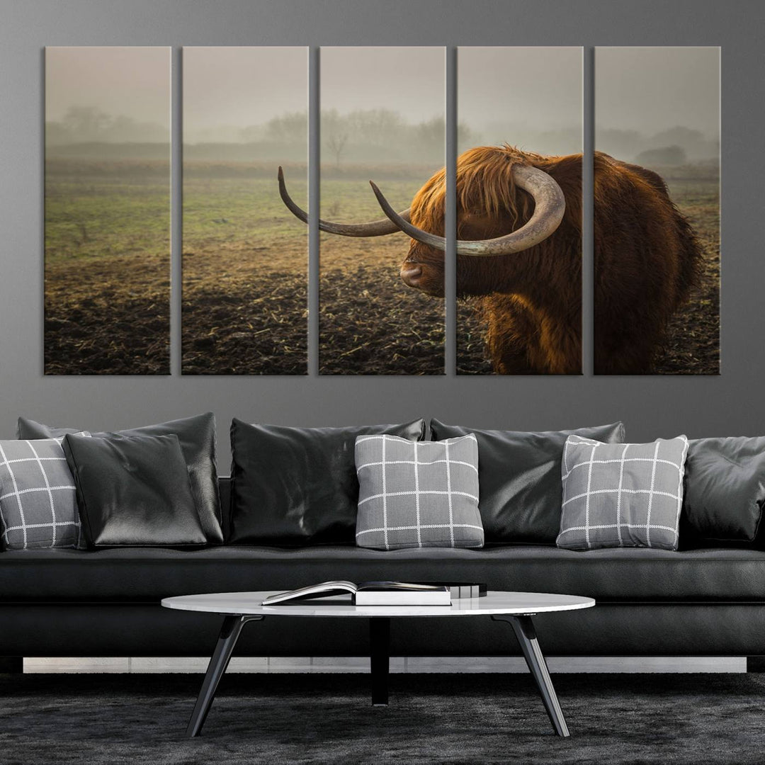 The "Big Cow Horn Wall Art Canvas Print" is a hand-assembled framed canvas depicting a Highland cow in a misty field. It is crafted with a UV-protective coating to ensure lasting vibrancy.