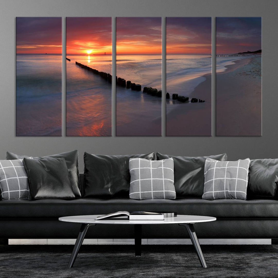 In a modern living room, the Sunset Beach Wall Art Canvas Print is displayed above. This triptych, printed on museum-quality canvas with a UV-protective coating, ensures lasting brilliance. It's ready to hang and brings an elegant touch to your space.